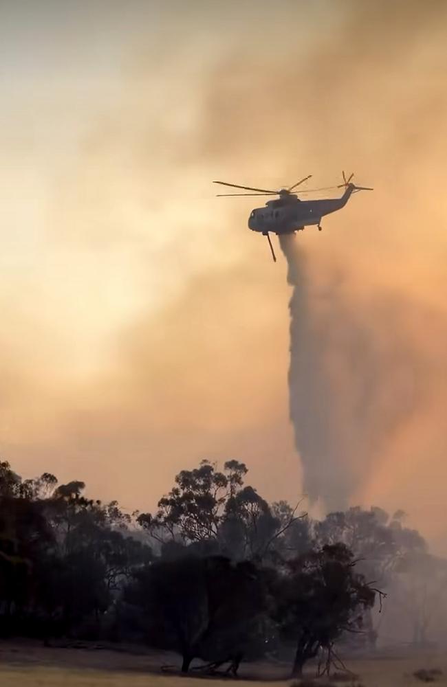 A helicopter drops water on a bushfire burning in the Grampians. Picture: Lexton CFA