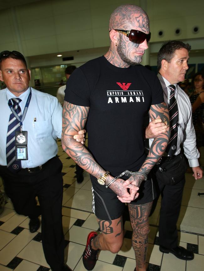 Brett "Kaos" Pechey arriving at Brisbane International airport in custody. Pic Mark Calleja