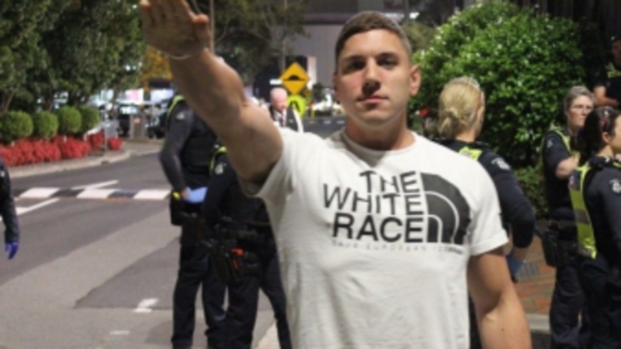 A neo-Nazi member performs salute in front of Police. Picture: Supplied,