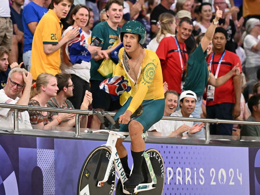 Australia's Sam Welsford reached for an Australian flag after the nation’s new “Awesome Foursome” won the men's track cycling team pursuit. Picture: Sebastien Bozon/AFP