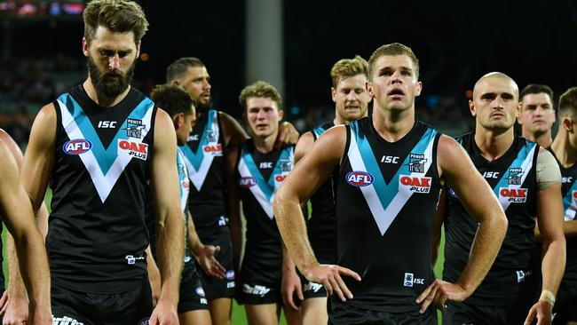 Dejected Port Adelaide players leave the ground after the loss to Richmond on Saturday night. Picture: Mark Brake/Getty Images