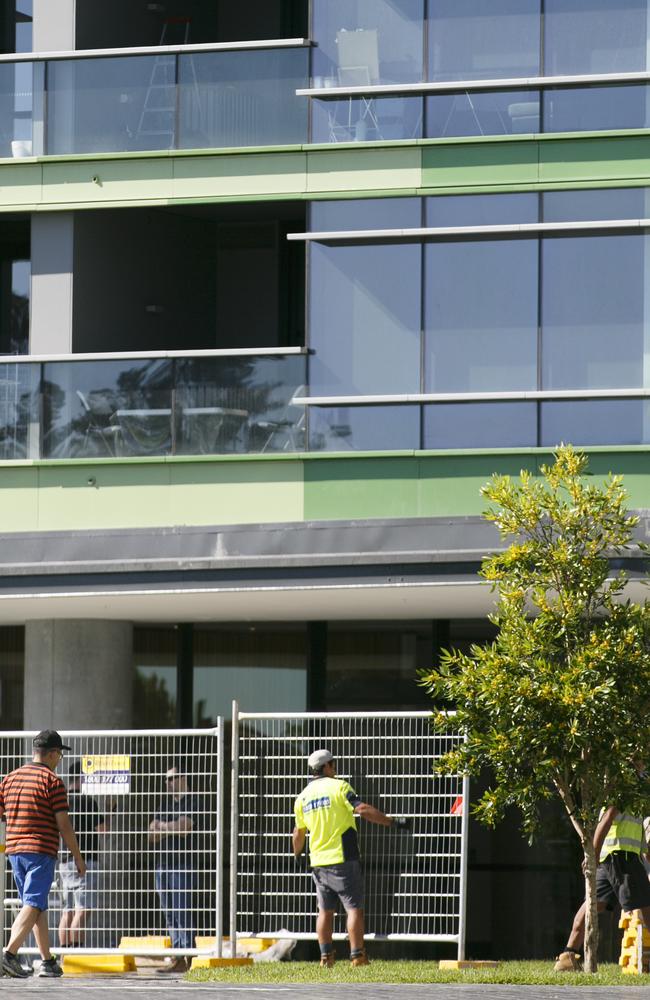 Workers put up scaffolding at Opal Tower to corner off a safe zone for the public. Picture: Tim Pascoe