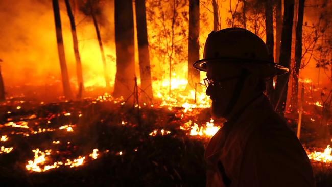 MALLACOOTA, AUSTRALIA - JANUARY 02: DELWP ( The Department of Environment, Land, Water and Planning ) and CFA ( Country Fire Authority ) Crews monitor fires and begin back burns between the towns of Orbost and Lakes Entrance in east Gipplsland  on January 02, 2020 in Australia. The HMAS Choules docked outside of Mallacoota this morning to evacuate thousands of people stranded in the remote coastal town following fires across East Gippsland which have killed one person and destroyed dozens of properties. (Photo by Darrian Traynor/Getty Images)