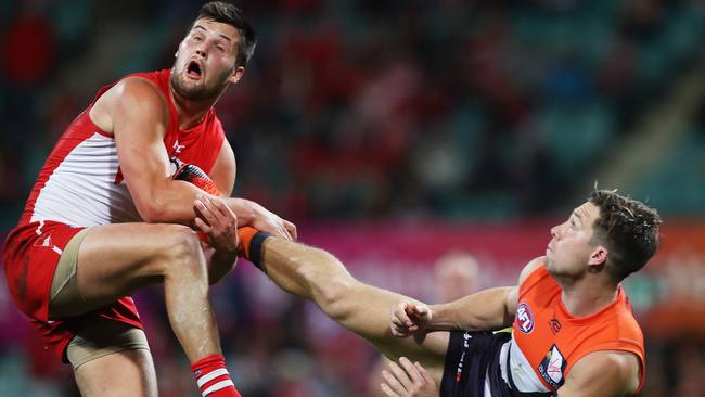 Toby Greene fends off Nic Newman with his foot. Picture: Phil Hillyard