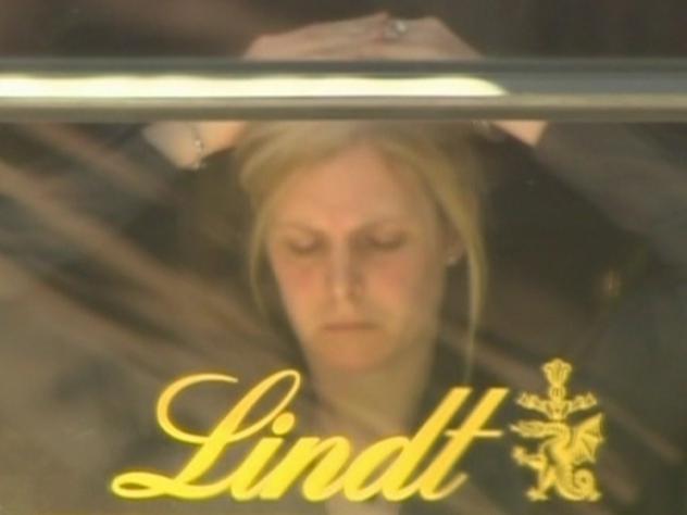 Julie Taylor. Channel 7 screen grabs of the Lindt Martin Place terror hostage. Muslim flag at the window, sniper.