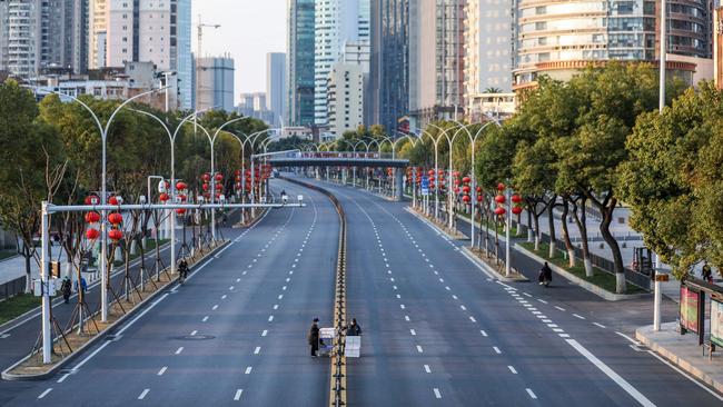 Schools could be closed and workers urged to work from home in some scenarios – such is the case already in Wuhan, China, where the outbreak originated. Picture: STR / AFP