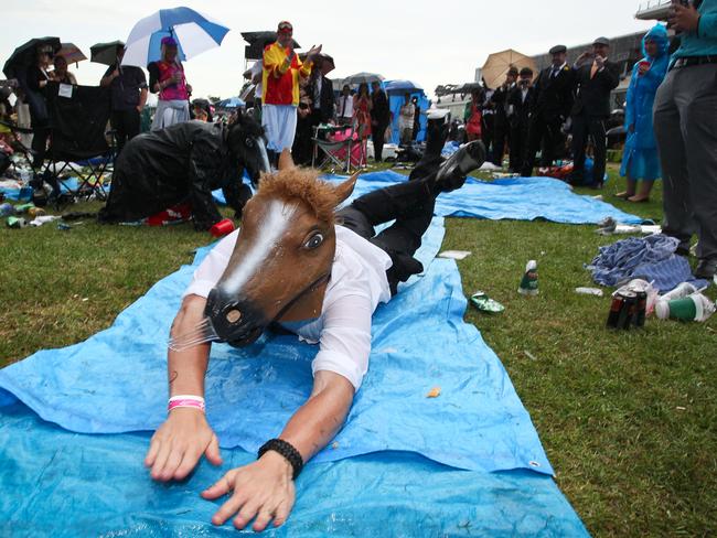 Racegoers make the most of wet conditions by setting up a slip n' slide in 2012.