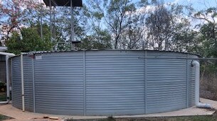 Connie Bright's water tank, pictured, has had to be refilled each dry season by defence as the wet hasn't filled them up. Picture: Supplied