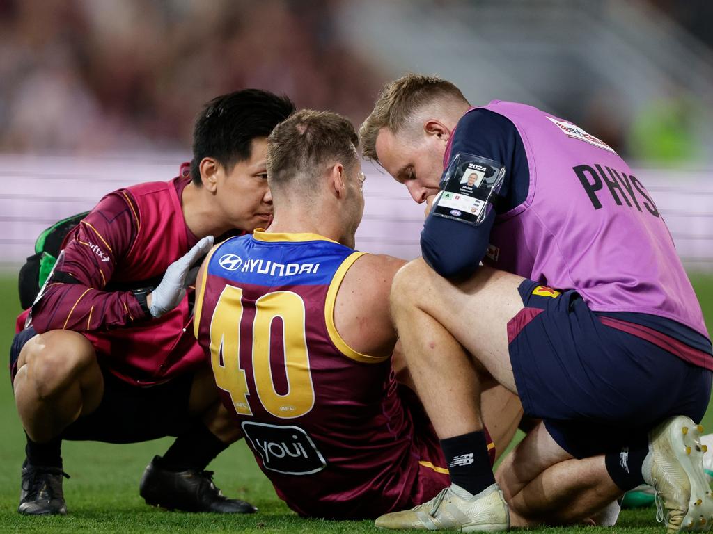 BRISBANE, AUSTRALIA – SEPTEMBER 07: Jack Payne of the Lions is seen in the hands of trainers during the 2024 AFL First Elimination Final match between the Brisbane Lions and the Carlton Blues at The Gabba on September 07, 2024 in Brisbane, Australia. (Photo by Russell Freeman/AFL Photos via Getty Images)