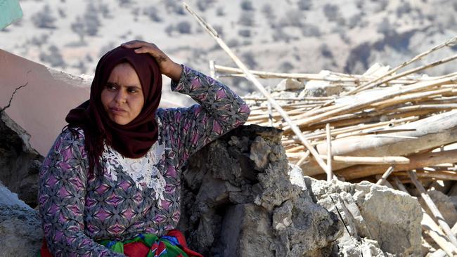 A woman sits on the rubble of a home in Imoulas village of the Taroudant province, one of the most devastated in quake-hit Morocco. Picture: AFP