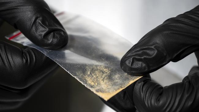 Alex Krotulski, 32, associate director and forensic toxicologist, holds a nitazene powder sample at the Center for Forensic Science Research and Education on Friday, Oct. 20, 2023, in Willow Grove, Pa. Nitazenes are a class of synthetic opioids typically sold as heroin and are estimated to be several times more potent than fentanyl.(Photo by Joe Lamberti for The Washington Post via Getty Images)