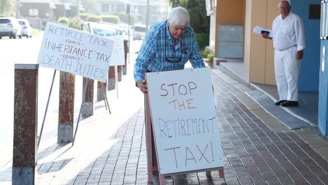 Jonathon Gaul protesting outside the hearing on Monday and called the plan a “death tax”. Picture: Hollie Adams