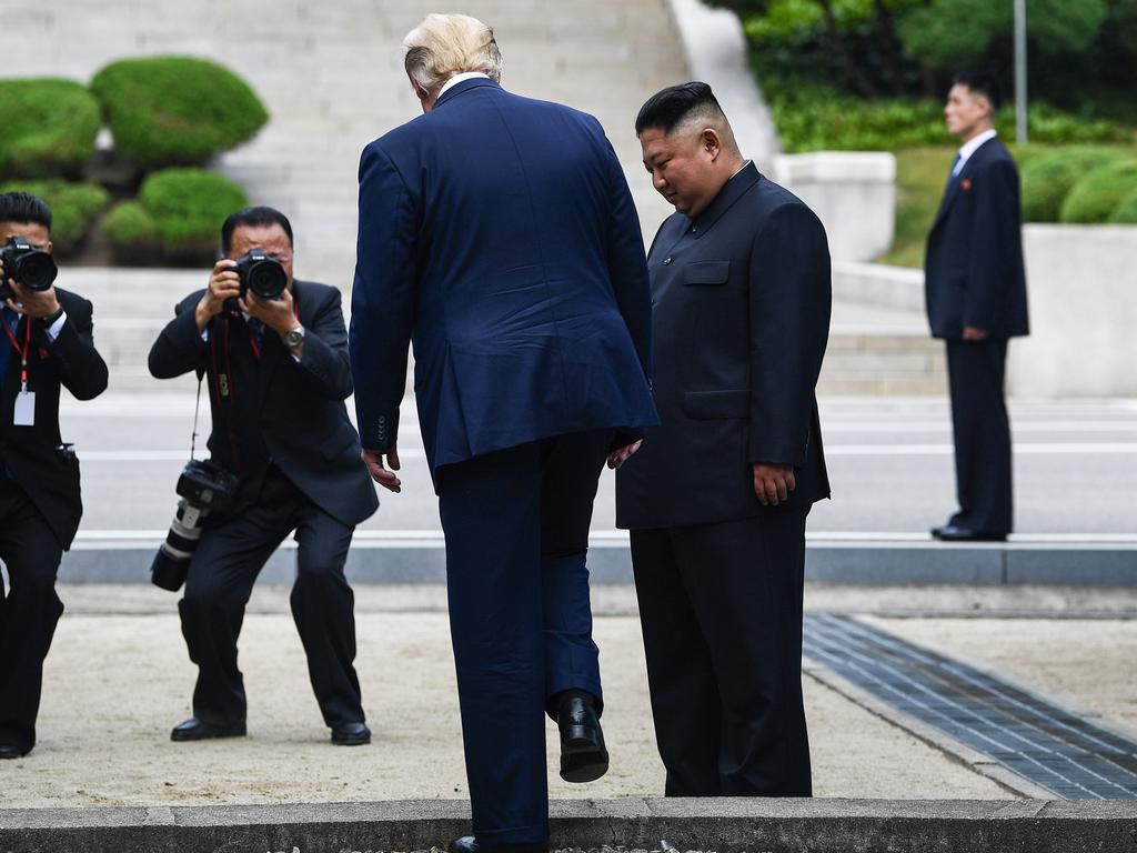 US President Donald Trump steps into the northern side of the Military Demarcation Line that divides North and South Korea. Picture: Brendan Smialowski/AFP