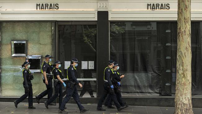 Police officers walk past a closed business on Bourke Street in Melbourne last October. Picture: NCA NewsWire/Daniel Pockett