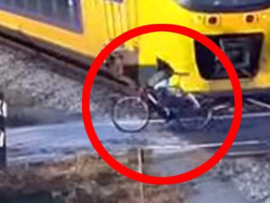 Cyclist narrowly avoids being hit by a train in the Netherlands. Picture: ProRail/Youtube