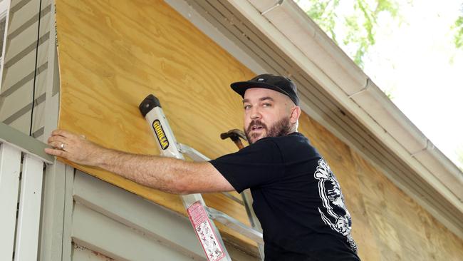 Doug Shobbrook from Redcliffe, using the stateboard ramp plywood to cover windows on the house, people prepping businesses, cafes and houses ahead of Cyclone Alfred, on the Redcliffe peninsular - on Tuesday 4th March 2025 - Photo Steve Pohlner