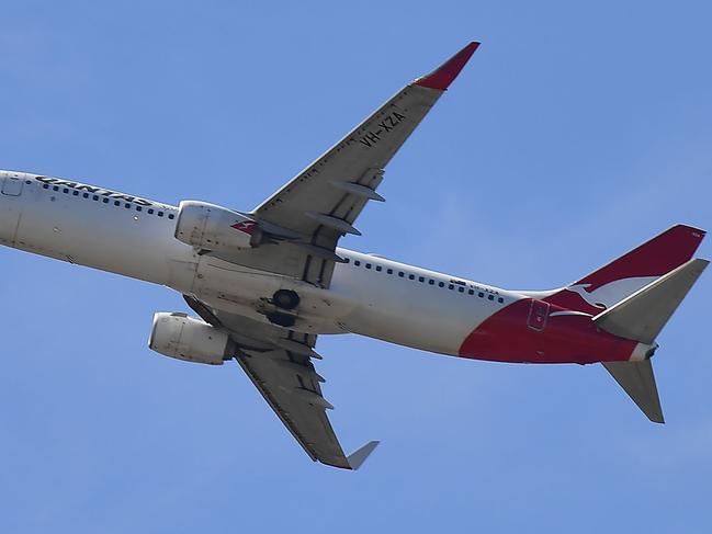 A Qantas Airways plane makes its move after taking off from the Sydney Airport in Sydney on March 19, 2020. - Australia's biggest airline Qantas said it would halt all international flights and suspend 20,000 staff in response to the coronavirus pandemic, days after the island nation's other main carrier Virgin shut its overseas routes. (Photo by Saeed KHAN / AFP)