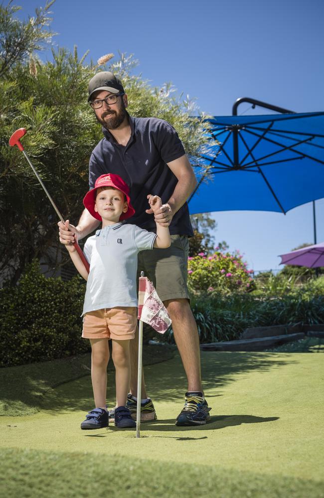 Mark Fuller and son Campbell Fuller having fun on the mini golf course on the school holidays at City Golf Club. Picture: Kevin Farmer