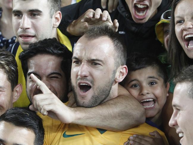 Fans celebrate with Australia's Ivan Franjic, center, after winning the AFC Asian Cup final soccer match between South Korea and Australia in Sydney, Australia, Saturday, Jan. 31, 2015. (AP Photo/Quentin Jones)