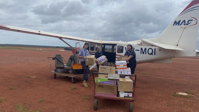 Mission Aviation Fellowship staff loading emergency supplies at Gove Airport.