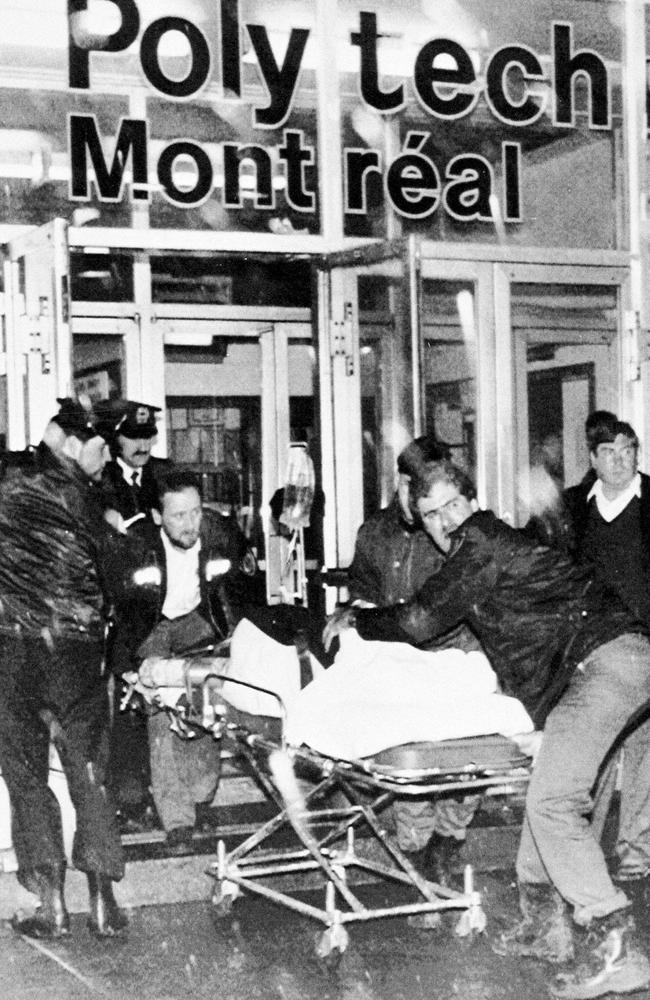 One of the injured in the University of Montreal mass shooting is wheeled away from the scene. (AP Photo)