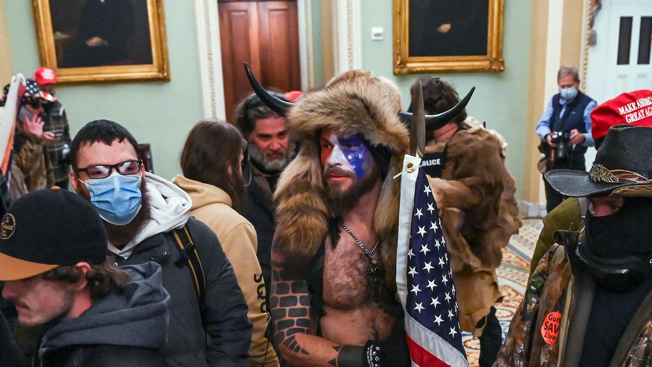 Supporters of US President Donald Trump, including Jake Angeli (C), a QAnon supporter, enter the Capitol in Washington, DC. Picture: Saul Loeb/AFP