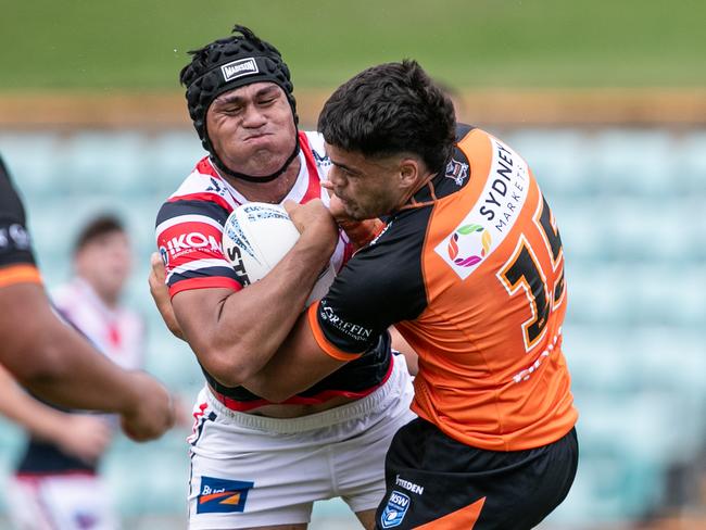 Aholoka Toia tackles Roosters player De La Salle Va'a. Picture: Julian Andrews