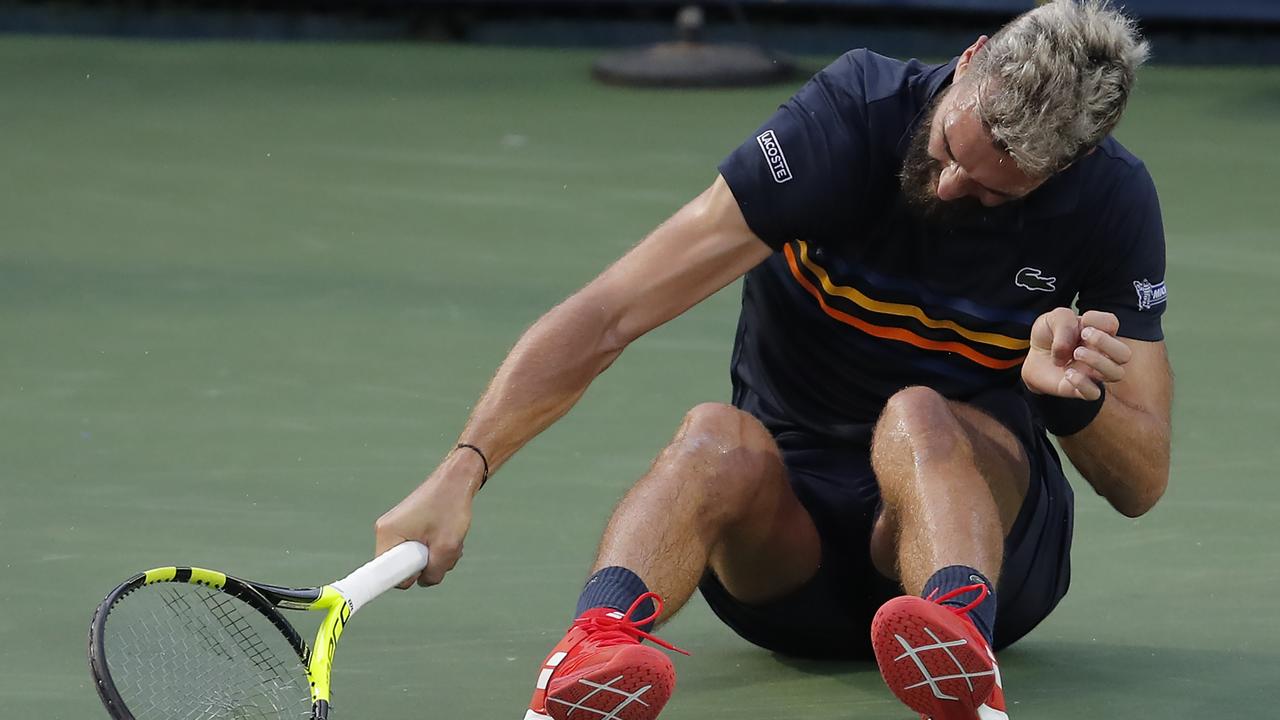 Benoit Paire smashes his racquet after losing to Marcos Baghdatis.