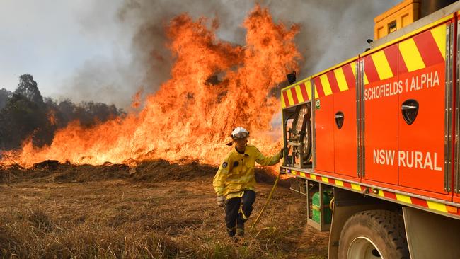 NSW Rural Fire Service members fight a blaze off Long Gully Road in the northeast NSW town of Drake on Monday. Picture: AAP