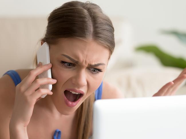 Angry dissatisfied young woman calling customer support or mobile banking, displeased client complaining about bad service, arguing on phone, having conflict during telephone conversation at home