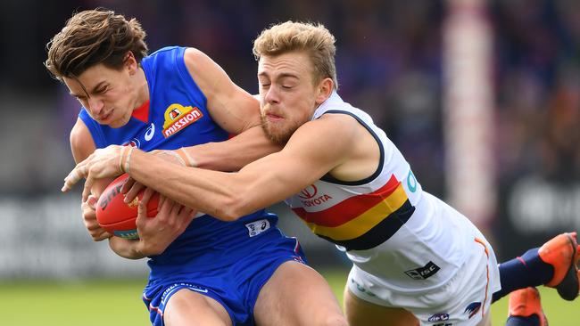 Patrick Lipinski of the Bulldogs is tackled by Crow Hugh Greenwood. Picture: Quinn Rooney/Getty Images