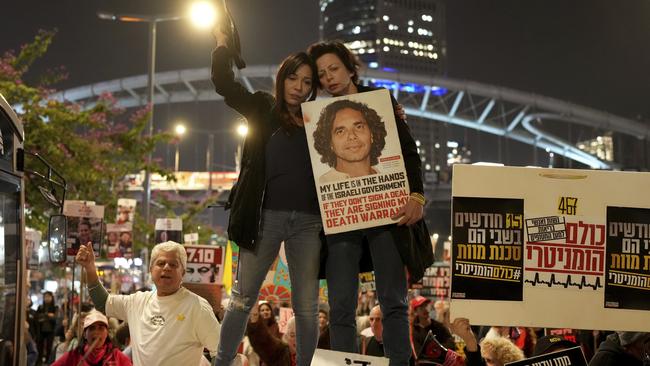 Relatives and friends of people killed and abducted by Hamas react to the ceasefire announcement in Tel Aviv. Picture: AP