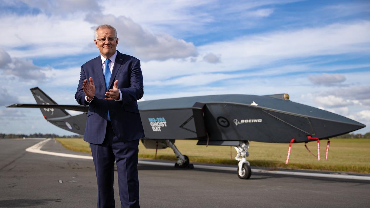 Prime Minister Scott Morrison with Ghost Bat drone. Prime Minister Scott Morrison visits RAAF base Amberley to announce the Government will deliver major airfield works across four sites at RAAF Bases Amberley, Pearce, Richmond, and HMAS Albatross that will maintain critical airfield infrastructure. Picture: Jason Edwards