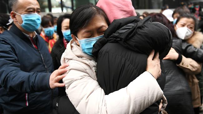 Family tearfully embrace a medical worker in Xian, central China, before he leaves for Wuhan’s coronavirus epicentre. Picture: Xinhua/Li Yibo