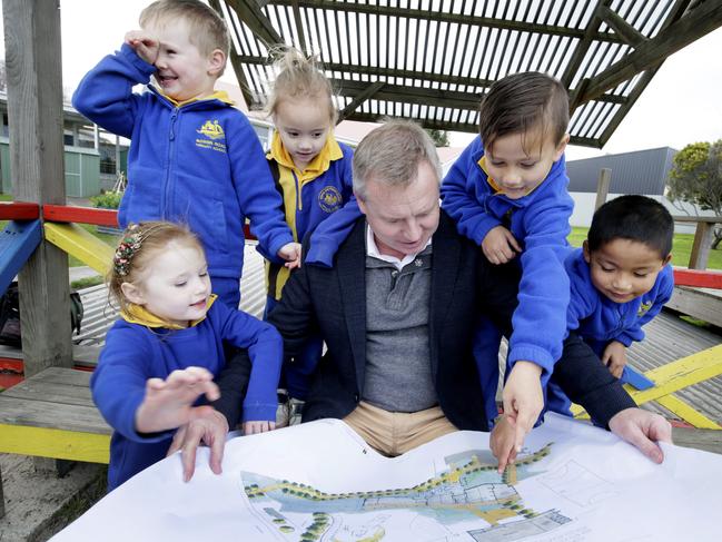 Tasmanian Education Minister, Jeremy Rockliff shows plans for their new school  to Bowen Road Primary School Kindergarten students from left, Ariana, Tyler, Piper, Nate and Eh Ser.