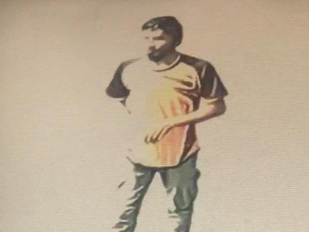 CCTV screen grab of Nur Islam walking towards the bank with a fuel container to set himself on fire at a Commonwealth Bank in Springvale.