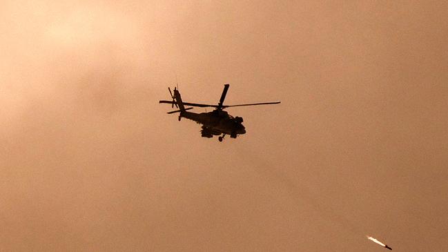 An Israeli military helicopter firing a missile towards Gaza amid continuing battles between Israel and the militant group Hamas. Picture: Jack Guez/AFP