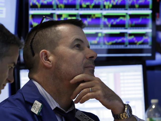 Specialist Michael McDonnell, right, works at his post on the floor of the New York Stock Exchange, Wednesday, Aug. 12, 2015. Another drop in China's currency sent global markets mostly lower on Wednesday as the move raised worries about the world's second-largest economy, but U.S. stocks recovered most of their losses in late trading. (AP Photo/Richard Drew)