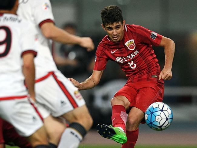 (FILES) This file photo taken on April 26, 2017 shows Shanghai SIPG Brazilian midfielder Oscar passing the ball during the AFC Asian Champions League group match between the Shanghai SIPG and South Korea’s FC Seoul in Shanghai.  The Chinese Football Association has stepped up its fight against spiralling big-money deals for foreign players by announcing prohibitive new curbs, less than a month before the next transfer window opens. / AFP PHOTO / Johannes EISELE
