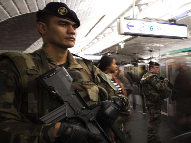 French soldiers stand guard in a metro station in Paris on November 17, 2015, as part of security measures set following Paris' attacks. Gunmen and suicide bombers went on a killing spree in Paris on November 13, attacking a concert hall, bars, restaurants and the Stade de France. Islamic State jihadists operating out of Iraq and Syria released a statement claiming responsibility for the coordinated attacks that killed 129 people and left 352 others injured. AFP PHOTO/JOEL SAGET