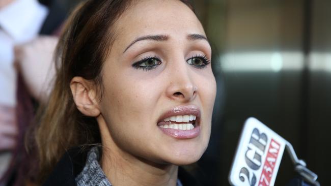 Ms Louise speaks to the media outside the court complex.