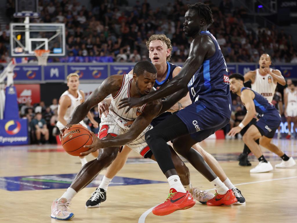 Hawks star Gary Clark attracts heavy attention from Luke Travers and Jo Lual-Acuil Jr of Melbourne United. Picture: Getty Images