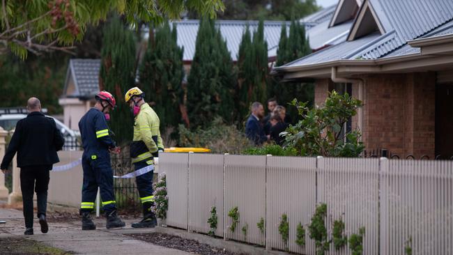 Police and firefighters outside the home at Angle Vale. Picture: Brett Hartwig