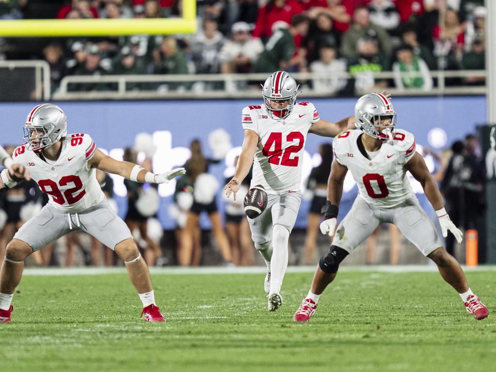 Joe McGuire punts against Michigan State. Picture: Zachery C. Kelly