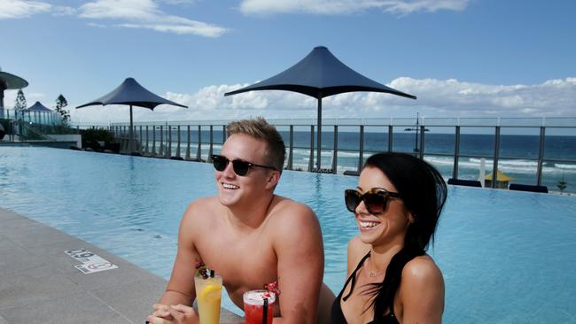 Clare Rigby, 21, and Luke Roberts 20, on the pool deck at Soul Mantra Surfers Paradise. Pic Tim Marsden