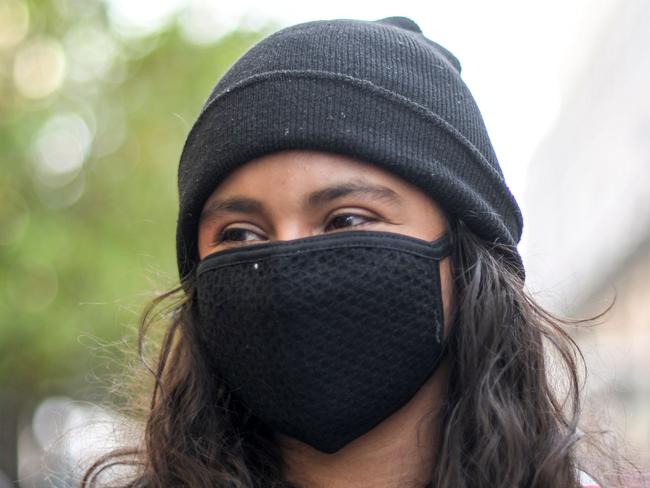 A girl wears a protective face mask while working as a preventive measure in the face of the global COVID-19 coronavirus pandemic, in Guatemala City, on March 13, 2020. - Guatemalan President Alejandro Giammattei confirmed on Friday the first case of the new coronavirus in a man who arrived from Italy. (Photo by Johan ORDONEZ / AFP)