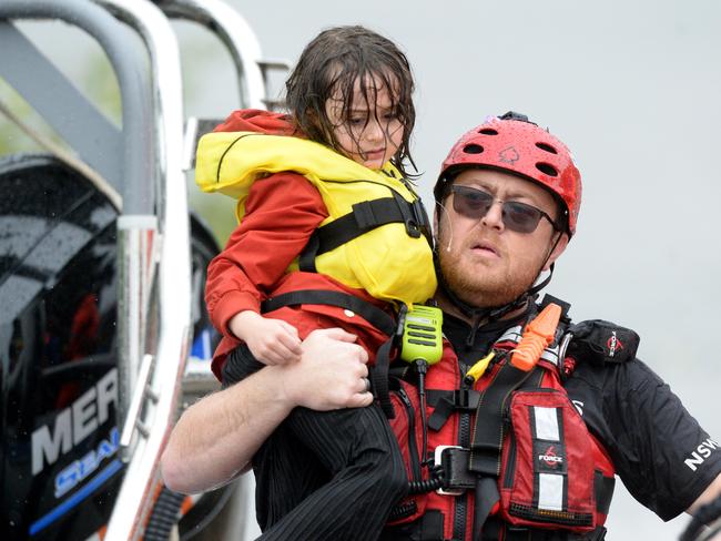 A brave child is rescued, along with her family, from their home in Upper Colo, NSW. Picture: NCA NewsWire/Jeremy Piper