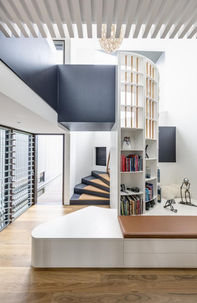 Even the samll areas work hard in this house. Clinton created this casual reading area in the smaller pavilion, with a sprial staircase leading up to the children’s bedrooms and lounge area.