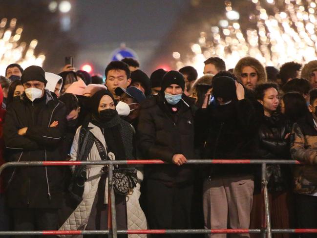 New Year's Eve revelers stand behind police barriers outside televised-only New Year's Eve celebrations held near the Brandenburg Gate on December 31, 2021 in Berlin, Germany. Picture: Getty