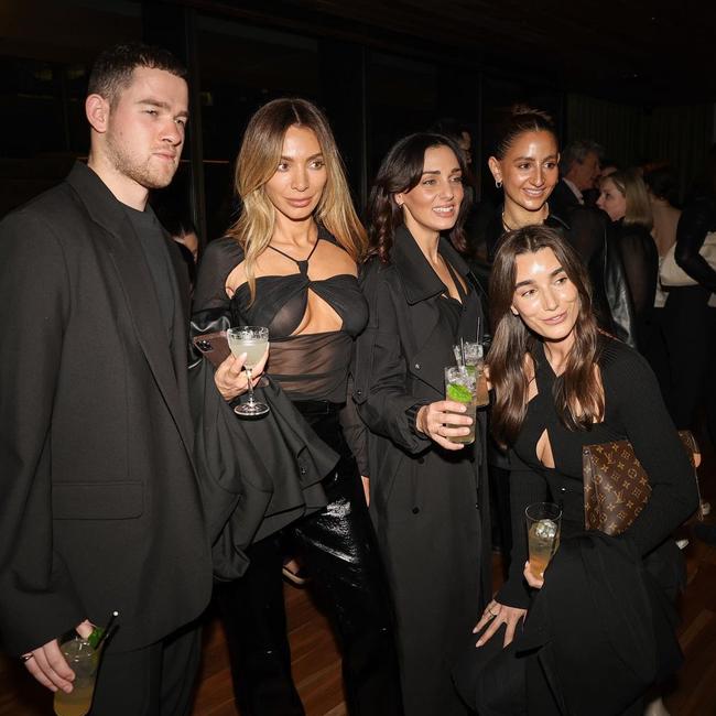 Nadia Bartel, 37, flaunts her toned figure in a revealing top and matching black pants as she poses alongside friends at an event in Melbourne on Thursday. Picture: Instagram/nadiabartel